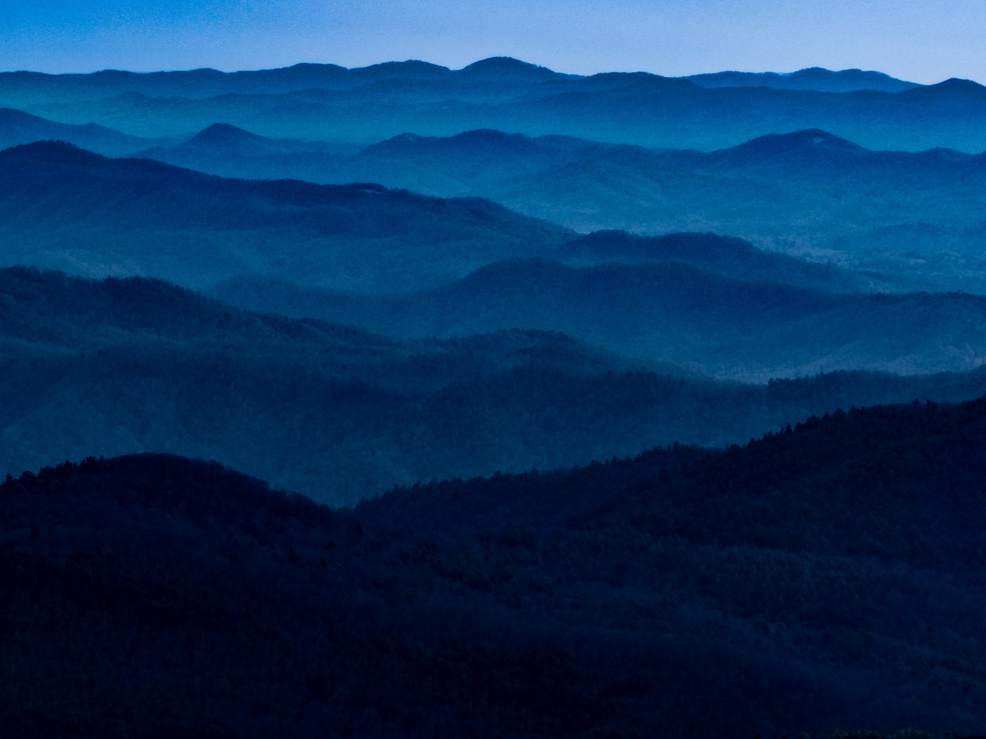 Layered mountain ridges in the North Carolina Blue Ridge fading into haze toward the horizon