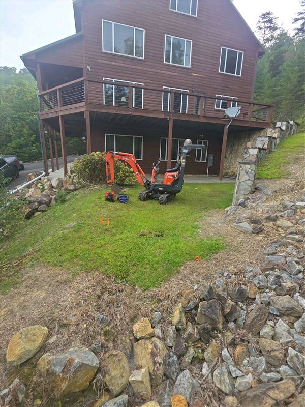 Mini excavator parked on a septic inspection job site