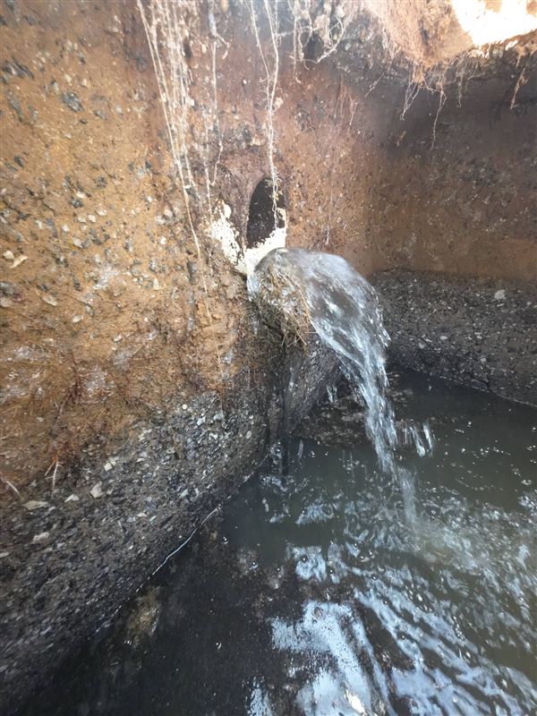 Water flowing into a septic tank through the inlet pipe